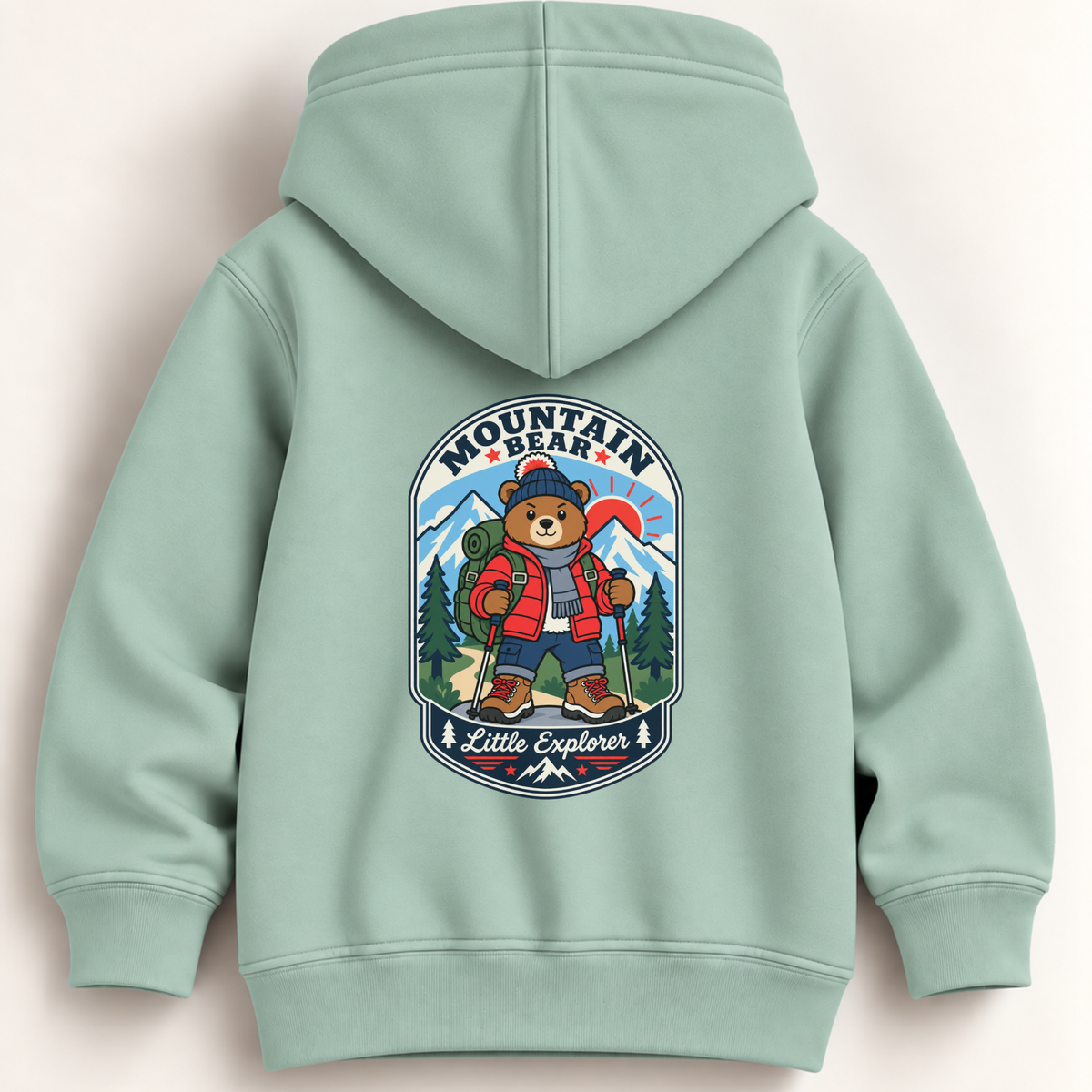 A mint green children's hoodie shown from the back, featuring a large colorful graphic of a cartoon bear hiking with the words 'MOUNTAIN BEAR' and 'Little Explorer'.