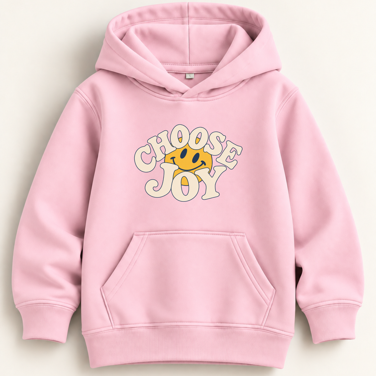 A light pink pullover hoodie with a front kangaroo pocket and a graphic on the chest that reads 'CHOOSE JOY' in cream bubble letters with a yellow smiley face inside, shown on a plain light background.