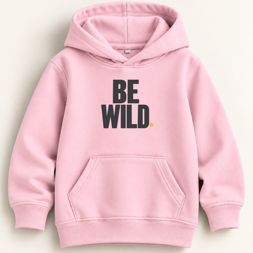 A light pink pullover hoodie with the words 'BE WILD.' printed in bold black letters on the chest, accompanied by a small yellow star accent, shown against a light beige background.
