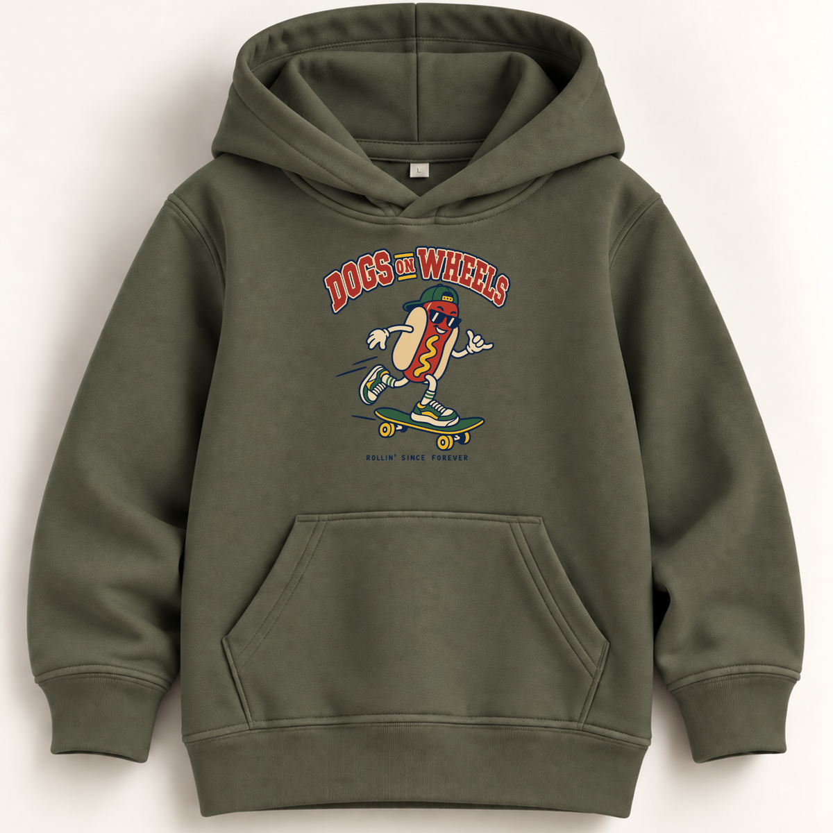 An olive green pullover hoodie with a front kangaroo pocket and a colorful graphic of a hot dog on a skateboard with the text 'DOGS ON WHEELS' on the chest, displayed against a light beige background.