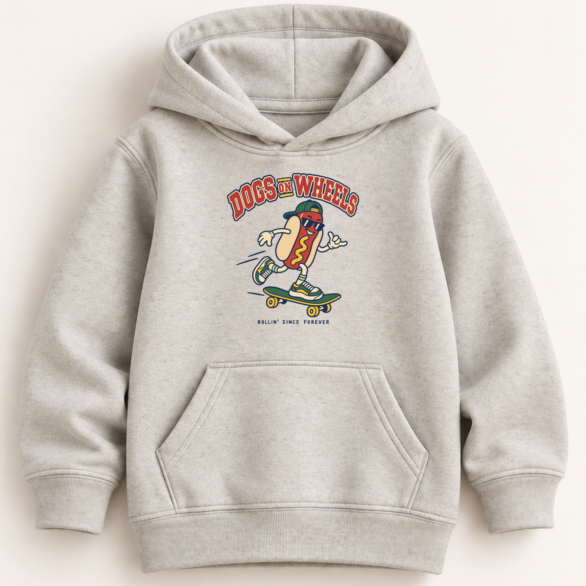 A light heather gray pullover hoodie with a front kangaroo pocket and a colorful graphic on the chest showing a hot dog character riding a skateboard under the words 'DOGS ON WHEELS'.