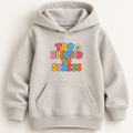 A light heather gray pullover hoodie with a colorful retro-style graphic on the chest reading 'TOO BLESSED TO STRESS' in multicolored bubble letters, with a small daisy flower above the text. The hoodie has a front kangaroo pocket and ribbed cuffs and hem, shown against a plain light beige background.
