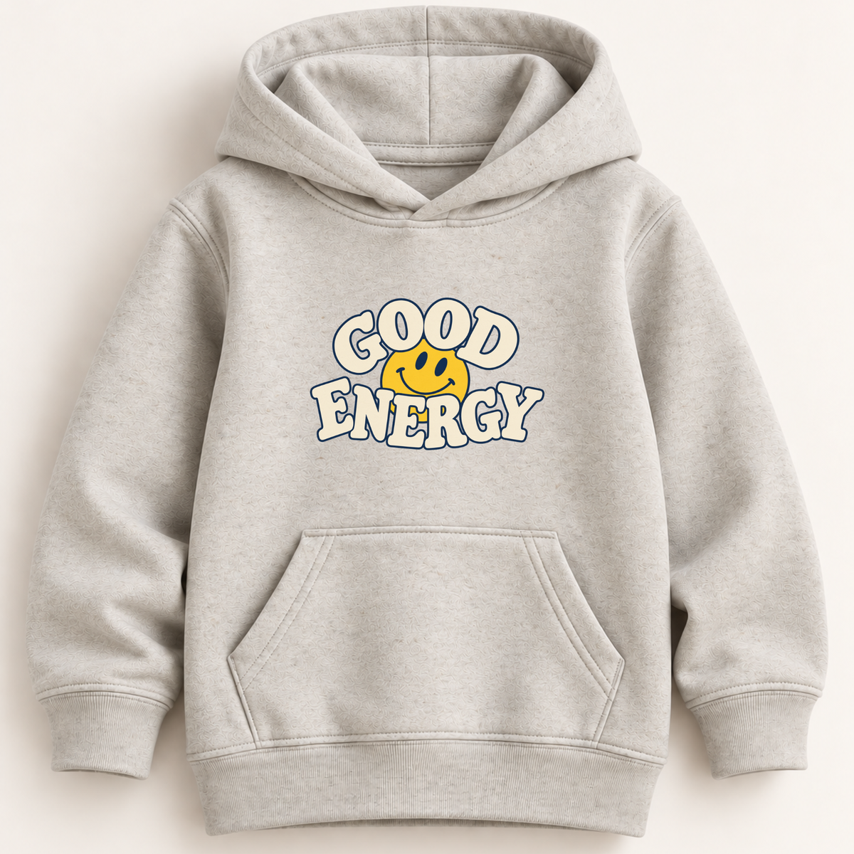 A light heather gray pullover hoodie with a front kangaroo pocket and a graphic on the chest that reads 'GOOD ENERGY' in white outlined letters around a yellow smiley face, shown on a plain light background.