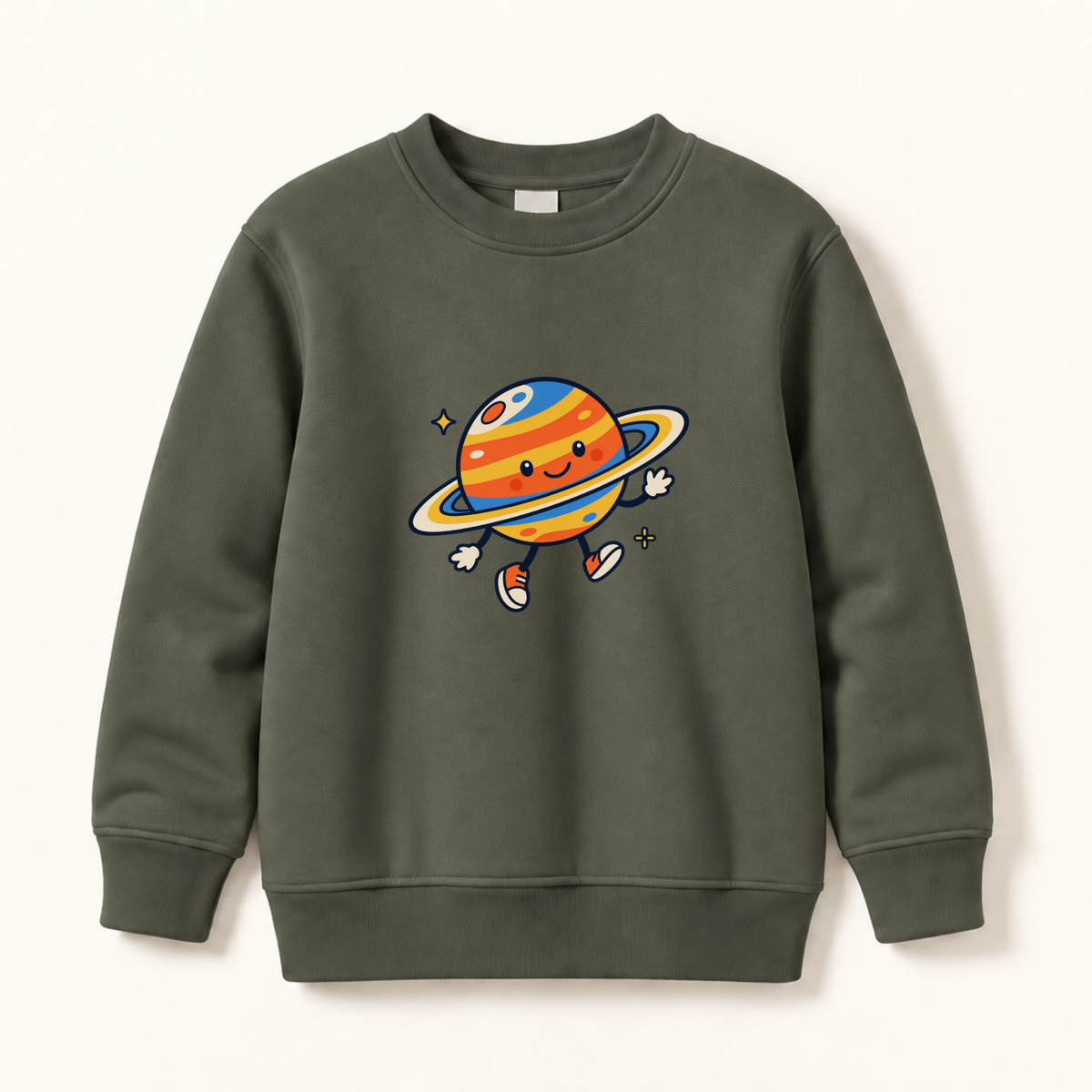 An olive green crewneck sweatshirt featuring a colorful cartoon graphic of a smiling planet with a ring on the chest, displayed against a light cream background.