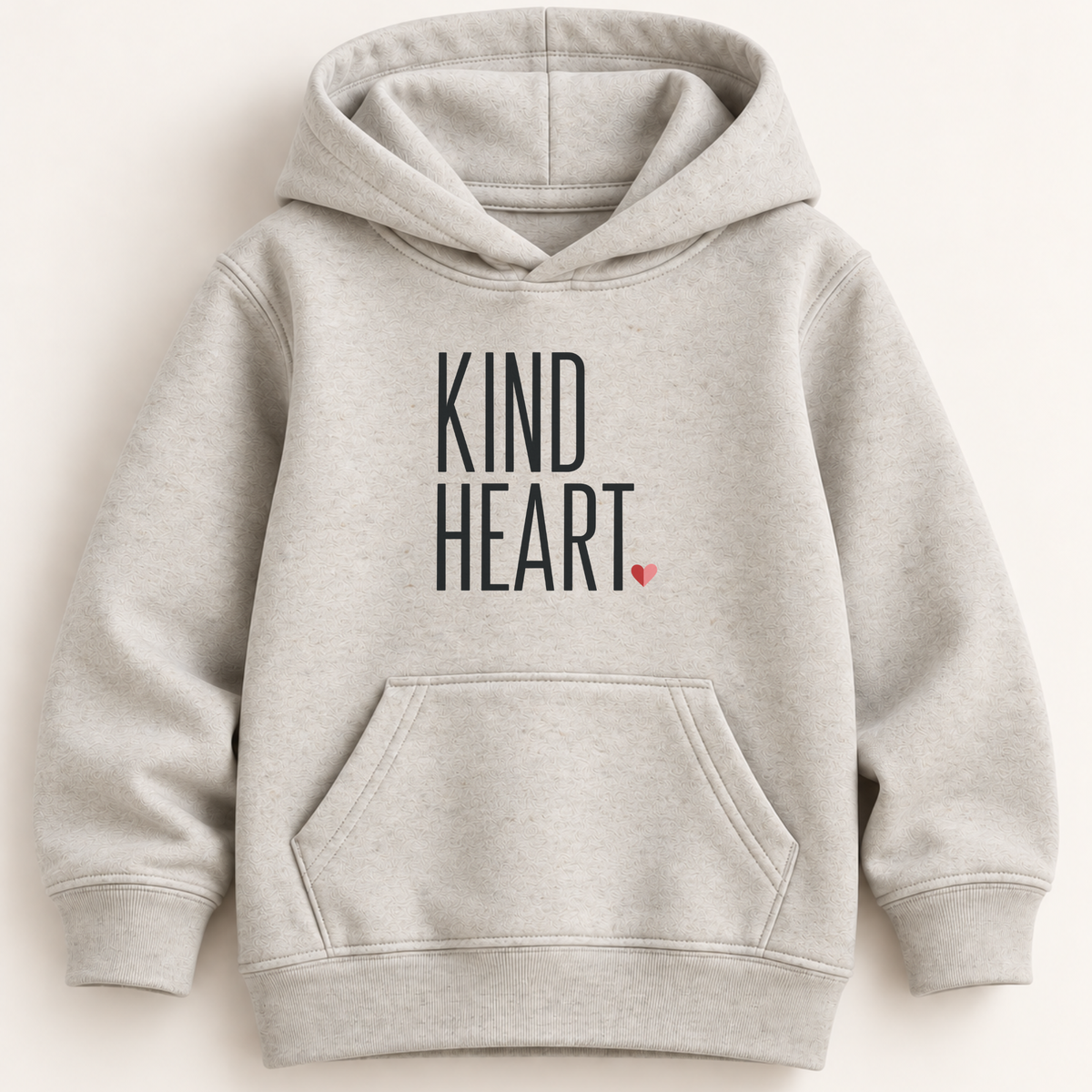 A light heather gray pullover hoodie with 'KIND HEART.' printed in black text and a small red heart on the chest, shown against a plain light beige background.