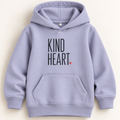A light lavender-purple pullover hoodie with 'KIND HEART.' printed in black block letters and a small red heart on the chest, displayed flat against a light cream background.