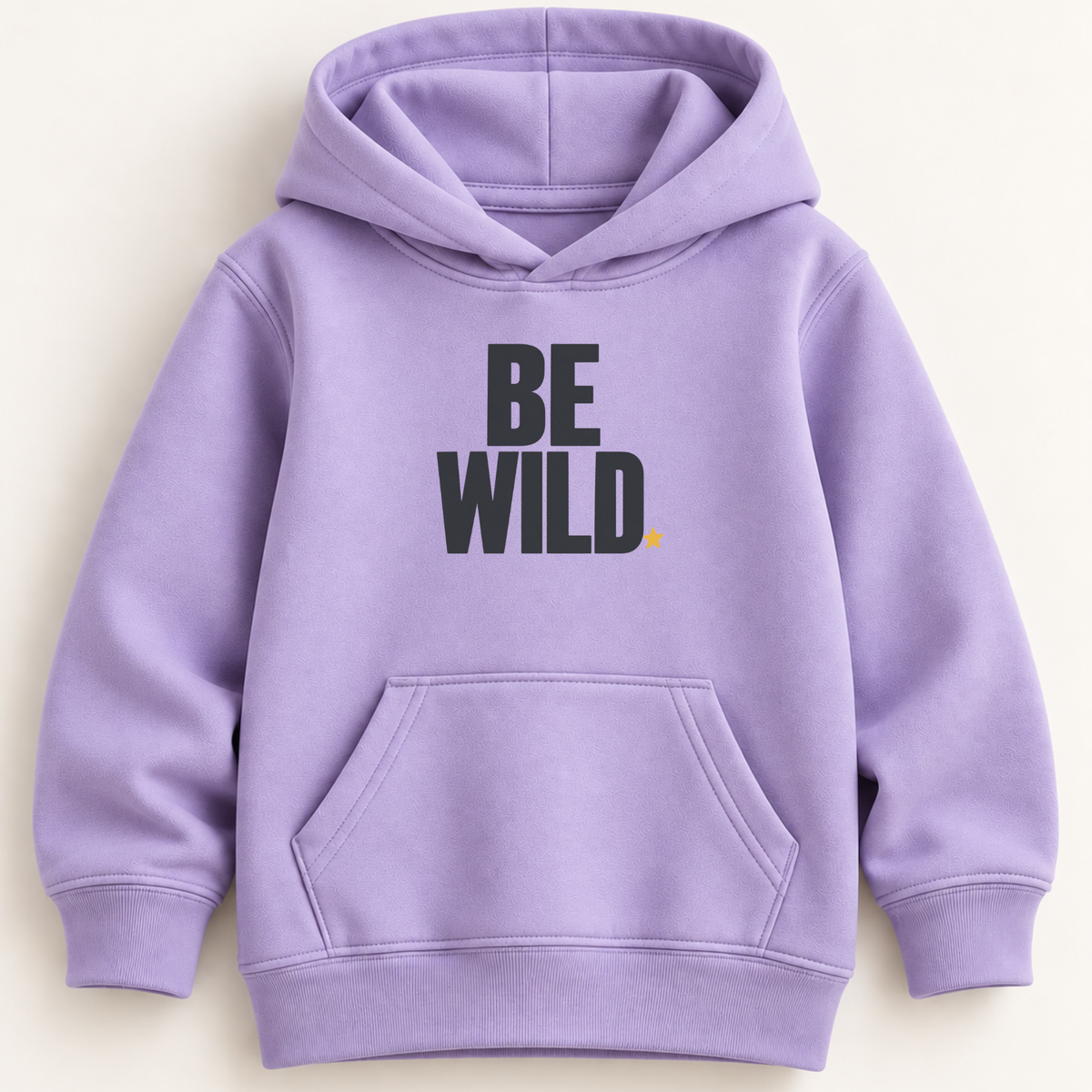 A lavender purple pullover hoodie with a front kangaroo pocket and the words 'BE WILD.' printed in bold black letters on the chest, with a tiny yellow star accent, shown against a light cream background.
