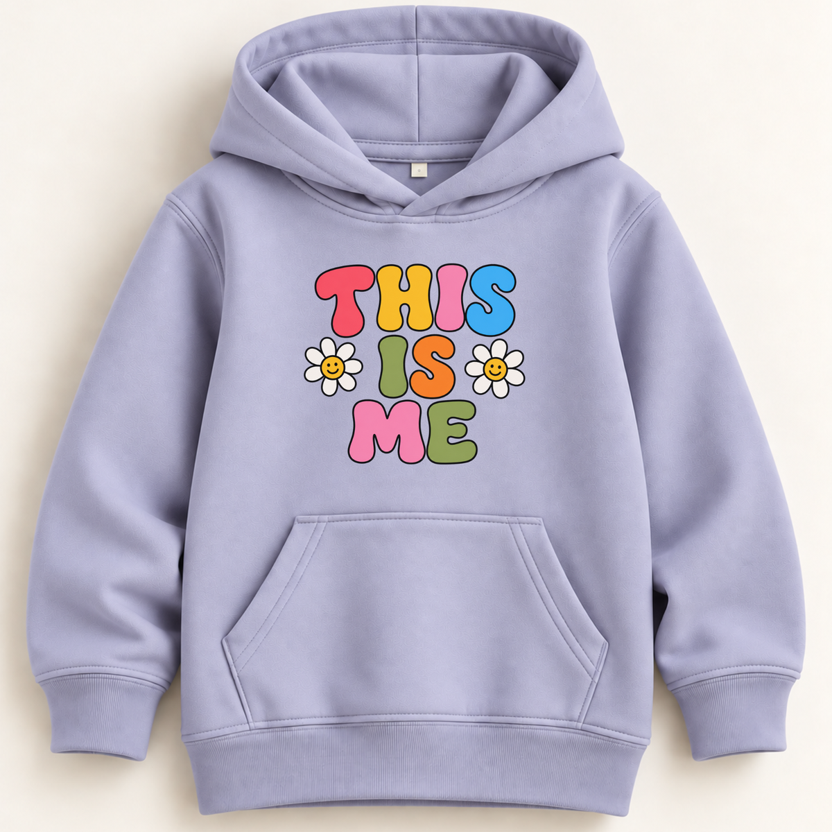 A light lavender-purple kids' pullover hoodie with a colorful graphic that reads 'THIS IS ME' in multicolored letters, accented by two white daisy flowers. The hoodie features a front kangaroo pocket and ribbed cuffs and hem, shown against a light cream background.