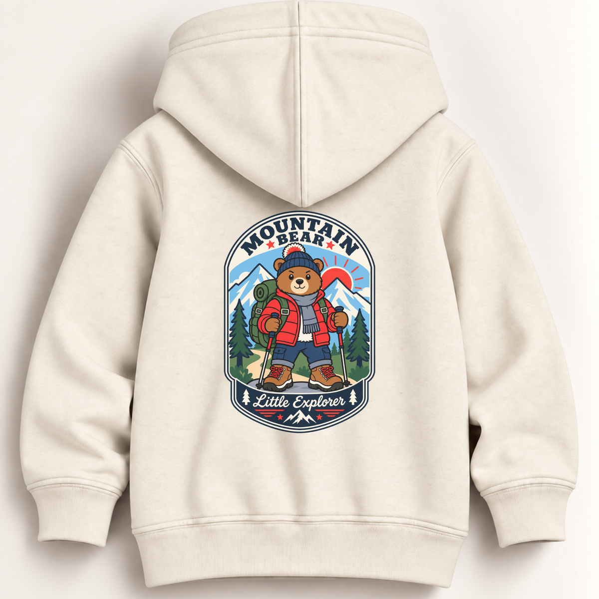 A cream-colored hooded sweatshirt shown from the back, featuring a large graphic print of a cartoon mountain bear wearing a red jacket and blue hat, with the text 'MOUNTAIN BEAR' and 'Little Explorer'.