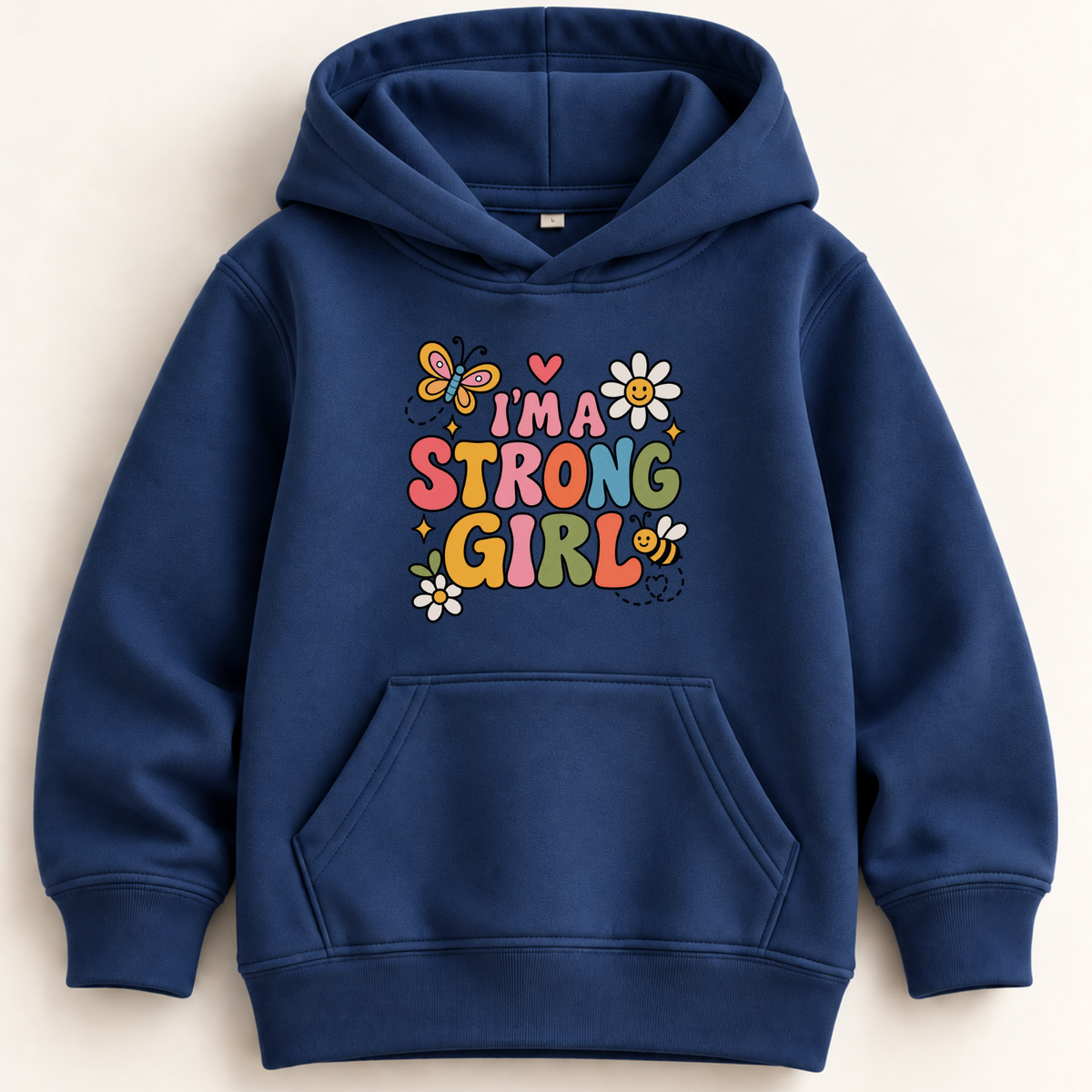 A navy blue kids' pullover hoodie with a colorful graphic on the chest that reads 'I'M A STRONG GIRL' surrounded by flowers, bees, and butterflies, shown against a light beige background.