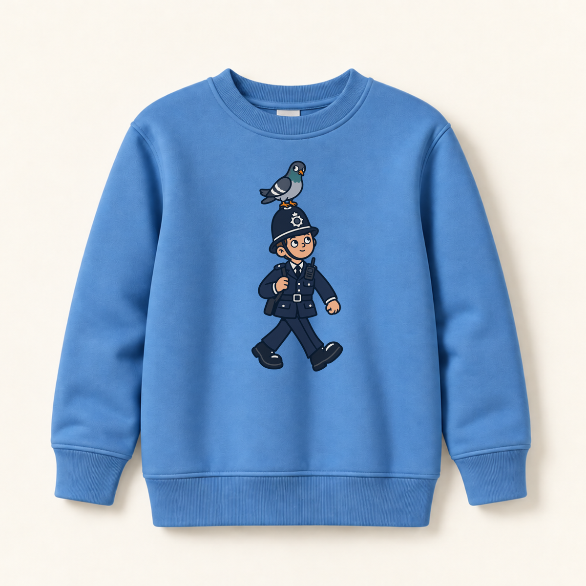 A blue crewneck sweatshirt featuring a cartoon graphic of a police officer walking with a pigeon on his helmet, displayed against a light cream background.