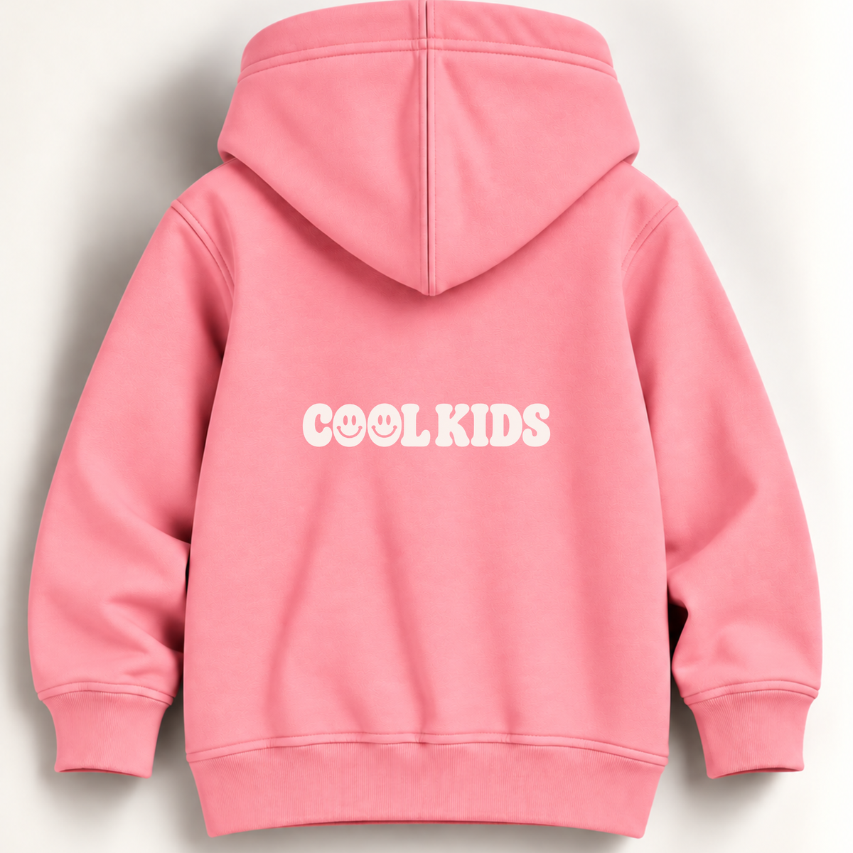 A pink hooded sweatshirt shown from the back, featuring the text 'COOL KIDS' printed in white across the center. The hoodie has a classic hood, long sleeves with ribbed cuffs, and a ribbed hem, photographed against a clean, off-white background.