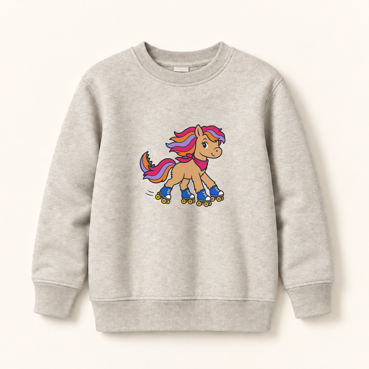 A light heather gray crewneck sweatshirt featuring a cartoon graphic of a tan pony with a pink and purple mane, wearing blue roller skates, displayed on a clean off-white background.