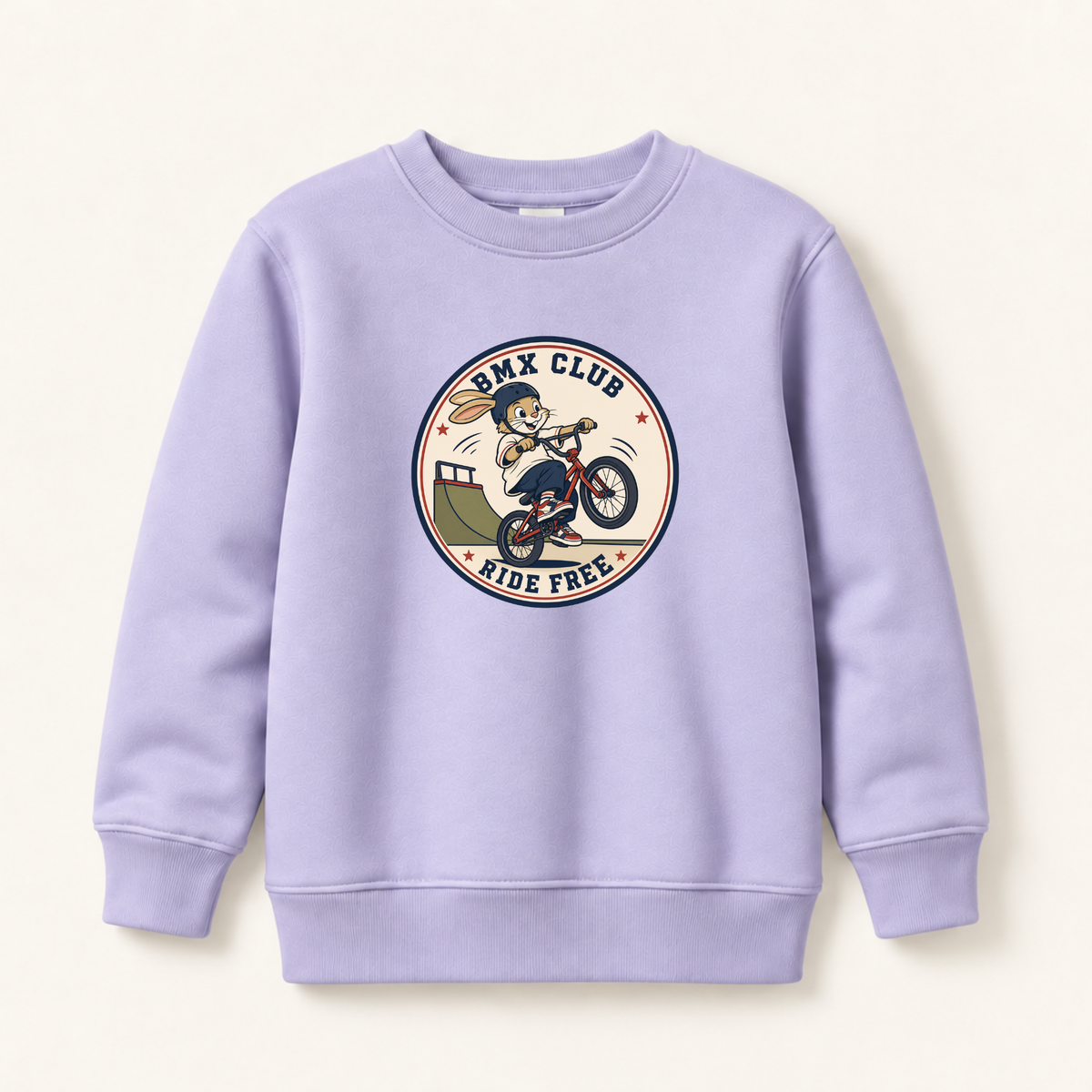 A light lavender crewneck sweatshirt featuring a circular retro-style graphic on the chest with a BMX rider and the text 'BMX CLUB RIDE FREE'.