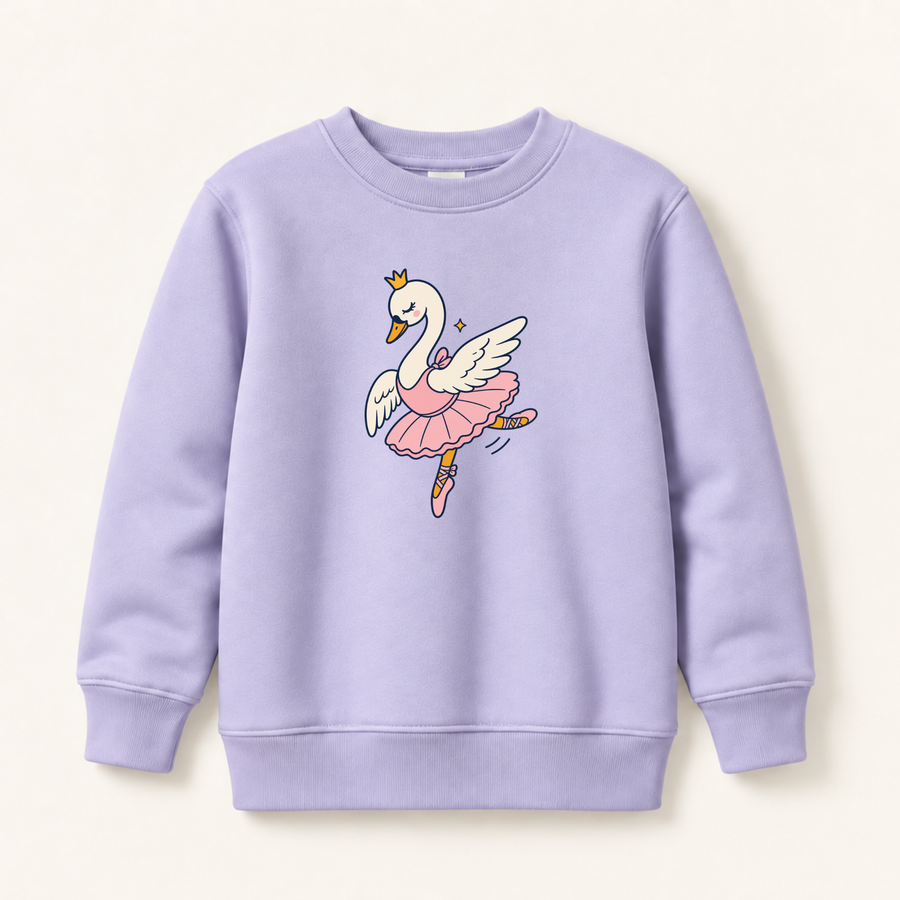 A light lavender crewneck sweatshirt featuring a cartoon graphic of a white swan ballerina with a pink tutu and gold crown, displayed on a warm off-white background.
