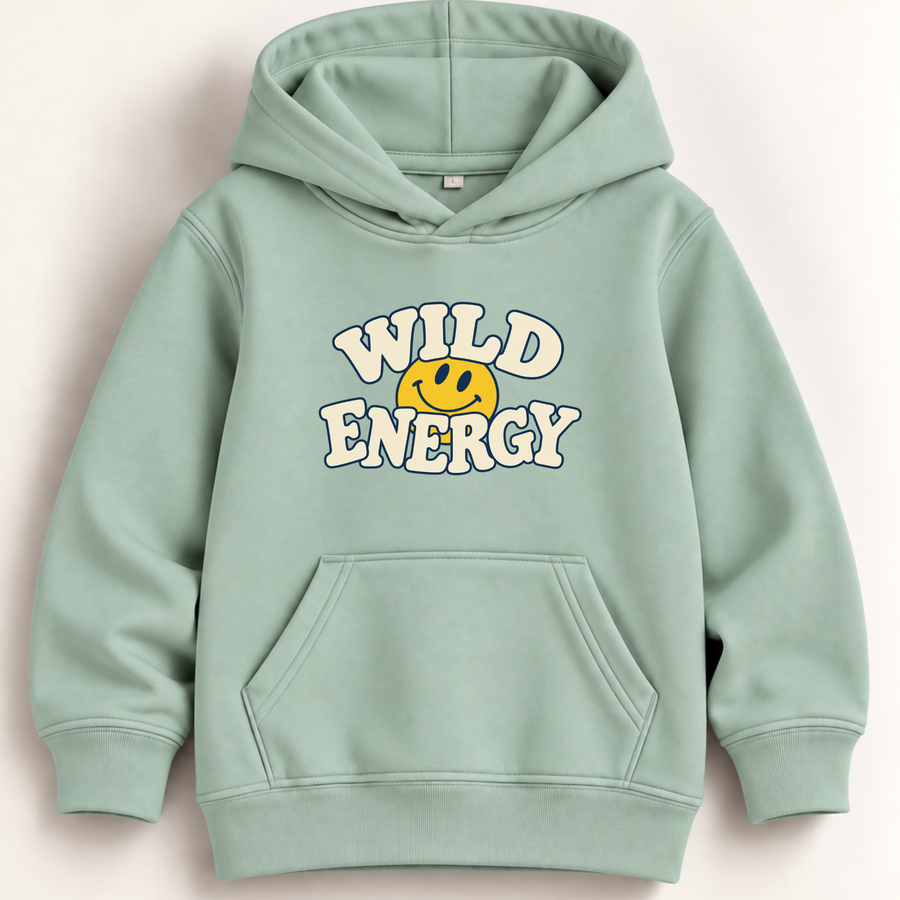 A sage green pullover hoodie with a front kangaroo pocket and a graphic on the chest that reads 'WILD ENERGY' in white bubble letters around a yellow smiley face, shown on a light beige background.