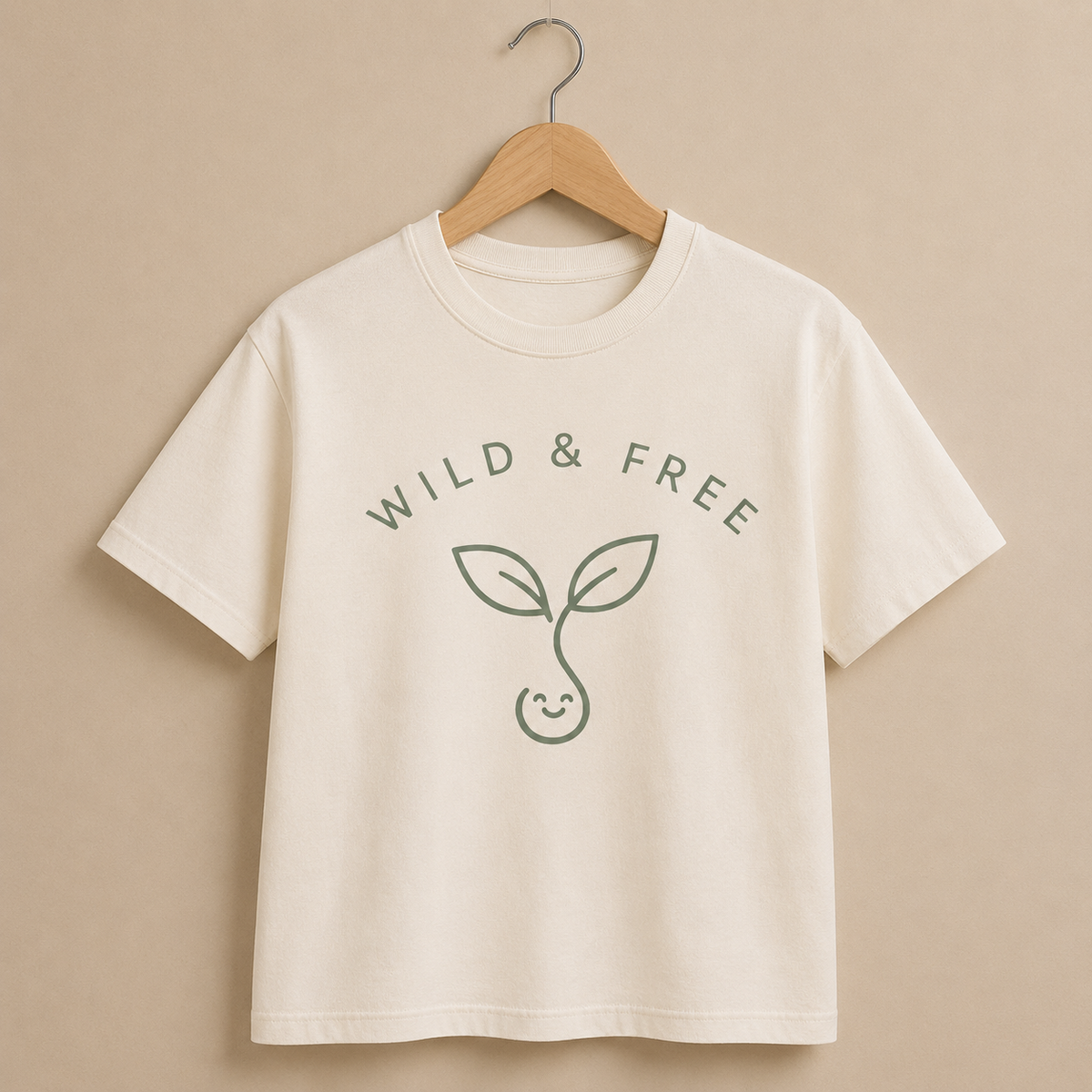 Beige t-shirt with 'Wild & Free' text and leaf design on a beige background